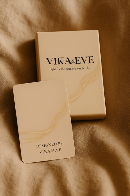 VIKA&EVE guidance card deck on a warm golden fabric background – minimalist spiritual aesthetic.