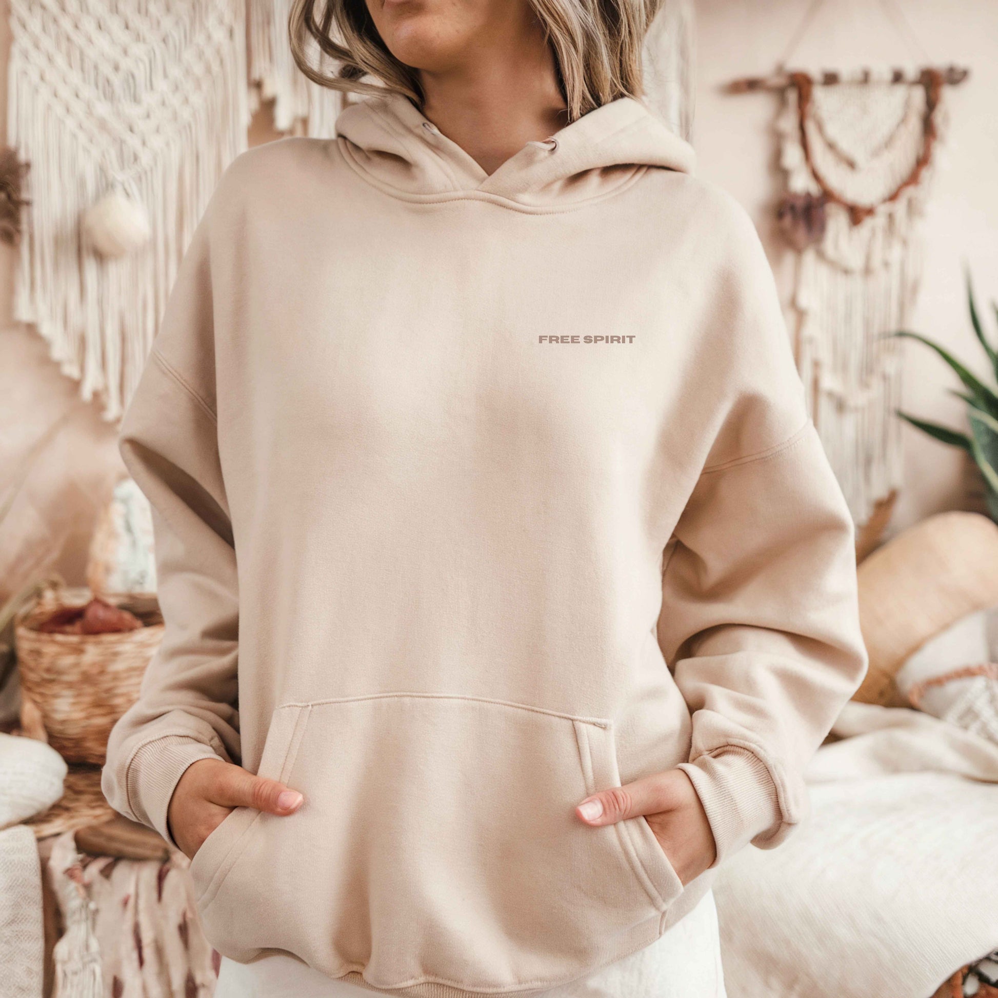 Model wearing sand oversized VIKA&EVE  FREE SPIRIT  hoodie indoor – minimalist unisex design for who we strive to be.